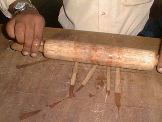Rolling the papyrus strips with a rolling pin