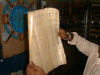 Finished papyrus sheet being held up